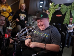 Jax Dorward, 17, smiles as he sits in his customized racecar wheelchair at his family's north Edmonton home on Thursday, December 10, 2015.At the age of nine-years-old, Jax lost the ability to walk after being diagnosed with spastic paraplegia by doctors at the Stollery Children's Hospital. He now spends much of his time volunteering at the Stollery. TREVOR ROBB/Edmonton Sun