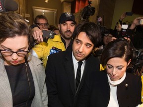 Jian Ghomeshi, centre, a former celebrity radio host who has been charged with multiple counts of sexual assault, leaves court alongside his lawyer Marie Henein, right, in Toronto, on Jan. 8, 2015. (REUTERS/Mark Blinch)
