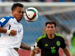 In this Nov. 17, 2015 photo, Honduras’ Arnold Peralta jumps for the ball during a World Cup qualifying match against Mexico  in San Pedro Sula, Honduras. (AP Photo/Moises Castillo)