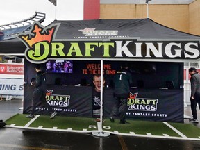 In this Oct. 25, 2015, photo, workers set up a DraftKings promotions tent in the parking lot of Gillette Stadium, in Foxborough, Mass., before a game between the New England Patriots and New York Jets. (AP Photo/Charles Krupa, File)