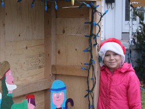 Emma Jones, 8, shows her favourite of the yard displays she created with her father, Greg Jones of Sarnia. The father and daughter team has been building Christmas memories for several years.
PHOTO TAKEN at Sarnia Ontario on Saturday, Dec.5, 2015
NEIL BOWEN/ SARNIA OBSERVER/ POSTMEDIA NETWORK