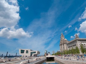 This May 15, 2009, photo released by VisitEngland shows the Mersey Ferries building at left and the Three Graces buildings at right in Liverpool, England. (Mark McNulty/VisitEngland via AP)
