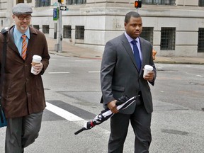 Baltimore City police officer William Porter, right, one of six Baltimore police officers charged with the death of Freddie Gray, walks to the courthouse with one of his attorneys in Baltimore. (Kevin Richardson/The Baltimore Sun via AP, File)