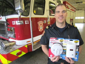 Mike Otis, fire life safety educator for Sarnia Fire Rescue Services, holds smoke and carbon monoxide detectors on Thursday December 10, 2015 in Sarnia, Ont. One of his safety tips for city residents during the holidays is giving the life-saving detectors as Christmas gifts.Paul Morden/Sarnia Observer/Postmedia Network