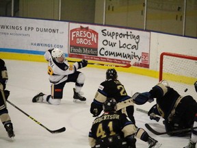 Dagger: Stony Plain Eagles forward Mat Knoll (top left) snipes home an insurance goal with five minutes to go, giving the Eagles a 6-4 lead over reigning provincial champion Bentley. - Mitch Goldenberg Reporter/Examiner