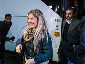 Syrian refugees arrive by bus to a hotel on Dixon Rd. near Toronto Pearson International Airport on Friday. (ERNEST DOROSZUK, Toronto Sun)