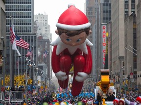 The Elf on the Shelf balloon floats down Sixth Avenue during the 88th Annual Macy's Thanksgiving Day Parade in New York November 27, 2014. The phenomenon known as "Elf on the Shelf" is a doll that surveils children in their homes and reports to Santa on their behaviour. REUTERS/Andrew Kelly