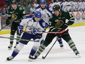 Mikkel Aagaard, left, of the Sudbury Wolves, and Kole Sherwood, of the London Knights, battle for possession of the puck during OHL action at the Sudbury Community Arena in Sudbury, Ont. on Friday December 11, 2015. John Lappa/Sudbury Star/Postmedia Network