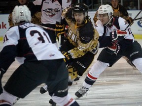 Sarnia Sting forward Matt Mistele carries the puck through the neutral zone with Windsor Spitfires Mikhail Sergachev and Christian Fischer defending during the Ontario Hockey League game at the Sarnia Sports and Entertainment Centre on Friday Dec. 11, 2015 in Sarnia, Ont. The West Division opponents met for the first time this season. Terry Bridge/Sarnia Observer/Postmedia Network