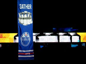 The banner recognizing Glen Sather's five Stanley Cup wins was raised to the rafters Friday night at Rexall Place (Ian Kucerak, Edmonton Sun).