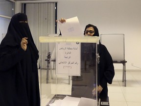 Saudi women vote at a polling center during the country's municipal elections in Riyadh, Saudi Arabia, Saturday, Dec. 12, 2015. Saudi women are heading to polling stations across the kingdom on Saturday, both as voters and candidates for the first time in this landmark election. (AP Photo/Aya Batrawy)