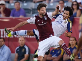 Colorado Rapids defender Drew Moor, left, collides with Real Salt Lake defender Tony Beltran as they pursue the ball in the first half of an MLS soccer match Saturday, July 11, 2015, in Commerce City, Colo. (AP Photo/David Zalubowski)