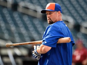 In this Sept. 2, 2015, file photo, New York Mets left fielder Michael Cuddyer adjusts his gloves during batting practice before a baseball game against the Philadelphia Phillies at Citi Field in New York. (AP Photo/Kathy Kmonicek, File)