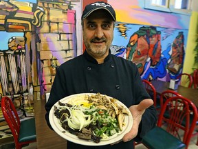 Talal Dalank, owner of Shawarma Time on Ellice Avenue in Winnipeg, displays a combination meat plate in his restaurant on Sat., Dec. 12, 2015. Profits from sales on Sunday and Monday are being donated to help Syrian refugees and they will also collect donations. (Kevin King/Winnipeg Sun/Postmedia Network)
