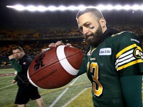 Edmonton Eskimos' quarterback Mike Reilly shows off the game ball and celebrate their win over the Calgary Stampeders in the CFL Western Final  at Commonwealth Stadium in Edmonton, Alberta on November 22, 2015.  Perry Mah/Edmonton Sun/Postmedia Network