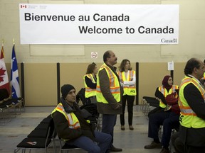 Immigration, Refugees and Citizenship Canada (IRCC) contractors including translators wait for the arrival of Syrian refugees at the Welcome Centre in Montreal, Quebec, December 12, 2015. The second military airlift of refugees is arriving in Montreal on Saturday, which will see a total of 10,000 resettled by year-end and an additional 15,000 by the end of February, fulfilling the Canadian government's pledge to accept 25,000.    REUTERS/Christinne Muschi