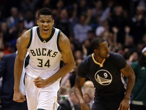 Milwaukee Bucks' Giannis Antetokounmpo (34) reacts after a made shot during the first half of an NBA basketball game against the Golden State Warriors Saturday, Dec. 12, 2015, in Milwaukee. (AP Photo/Aaron Gash)