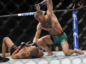 Conor McGregor lands punches to win b technical knockout  against Jose Aldo during UFC 194 at MGM Grand Garden Arena. Mandatory Credit: Gary A. Vasquez-USA TODAY Sports