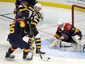 Kingston Frontenacs Jason Robertson can't gets a shot on Erie Otters goalie Devin Williams as Robertson is tied up by TJ Fergus during Ontario Hockey League action at the Rogers K-Rock Centre in Kingston on Saturday December 12 2015. Ian MacAlpine /The Kingston Whig-Standard/Postmedia Network