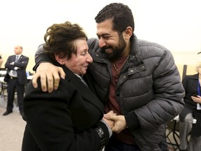 Anas Francis (R) is reunited with his grandmother Syrian refugee Laila Saeed at the Welcome Centre in Montreal, Quebec, December 12, 2015. The second military airlift of refugees arrived in Montreal on Saturday, and will see a total of 10,000 resettled by year-end and an additional 15,000 by the end of February, fulfilling the Canadian government's pledge to accept 25,000.  REUTERS/Christinne Muschi