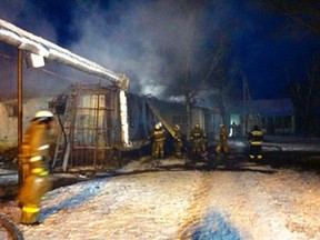 In this Russian Emergency Situations Ministry photo made available early Sunday, Dec. 13, 2015, firefighters work to put out a blaze at a Russian home for people with mental illness in Semiluki, Voronezh region, about 600 kilometres south of Moscow, Russia. Russian emergency services say more then 20 people died when a fire swept through a home for people suffering from mental illness, and 51 were rescued.(Russian Ministry for Emergency Situations photo via AP)