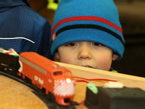 Thomas Webber, 4, watches as a model train goes around a track at the annual Christmas tree-lighting celebration at Anderson Farm Museum in Lively, Ont. on Saturday December 12, 2015.  John Lappa/Sudbury Star/Postmedia Network