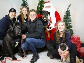 Winnipeg Sun columnist Doug Lunney and his family pose for a photo with Santa Claus, a.k.a. Tom Doerksen, in Lockport, Man. (SAMARA FUNK PHOTO/FOR THE WINNIPEG SUN/POSTMEDIA NETWORK)