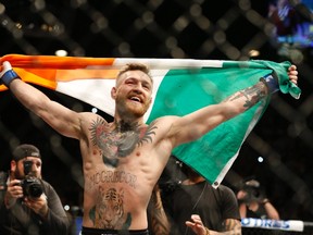 Conor McGregor reacts after defeating Jose Aldo during a featherweight championship mixed martial arts bout at UFC 194, Saturday, Dec. 12, 2015, in Las Vegas. (AP Photo/John Locher)