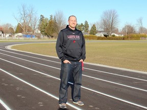 Ian Avery of the Dresden Community Development Association stands for the first time on the newly constructed six-lane track behind the Lambton-Kent Composite School in Dresden, Ont. on Friday December 11, 2015.