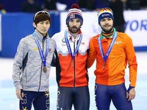 Charles Hamelin of Canada, center, the winner of the men's 1500m, poses for the media with runner up Sjinkie Knegt of the Netherlands, right, and second runner up Park Se Yeong of South Korea,  after the final of the men's 1500m during the ISU Short Track Speed Skating World Cup in Shanghai, China Saturday Dec. 12, 2015. (Chinatopix Via AP) CHINA OUT