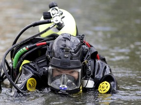A FBI diver searches the water at Seccombe Lake Park after a shooting earlier this month in San Bernardino, California December 11, 2015.  REUTERS/Jonathan Alcorn
