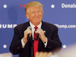 In this Dec. 1, 2015, file photo, U.S. Republican presidential candidate Donald Trump smiles as he arrives at a campaign stop at the White Mountain Athletic Club in Waterville Valley, N.H. (AP Photo/Jim Cole, File)