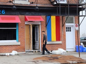 A man cleans up after fire damaged a downtown restaurant Sunday night. Ian MacAlpine/ The Whig-Standard