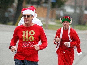 Ron Ameloot and Kevin O'Connor run in the fourth annual Jingle run on Dec. 12. A total of 118 runners and walkers took part. The event also had two truck loads of food donations taken to St. Vincent de Paul.