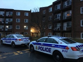 Two police cars sat outside an Arrowsmith Dr. apartment complex early Monday morning. The area was the scene of a shooting Sunday night, Ottawa's 43rd incident of gunfire during 2015. The victim was reported in serious condition. (DANI-ELLE DUBE Ottawa Sun / Postmedia Network)