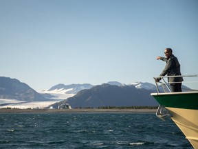 In this Sept. 1, 2015, file photo, President Barack Obama gestures towards Bear Glacier, which has receded 1.8 miles in approximately 100 years, while on a boat tour to see the effects of global warming in Resurrection Cove in Seward, Alaska. (AP Photo/Andrew Harnik, File)