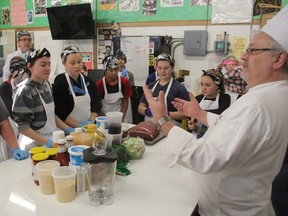Chef professor Thomas Elia tells students how to prepare the ingredients for a recipe for a slow cooker during a class at First Avenue Public School in Kingston, Ont. on Wednesday, Dec. 9, 2015. Michael Lea/The Whig-Standard/Postmedia Network