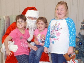 Gabriella Wenzel, left, her sister Jaidyn Wenzel and Claire Nantais enjoy their time with Santa, during the Pancakes with Santa breakfast held at the UAW Hall on Dec. 12. The event was a fundraiser for the Wallaceburg Thrashers senior lacrosse team.