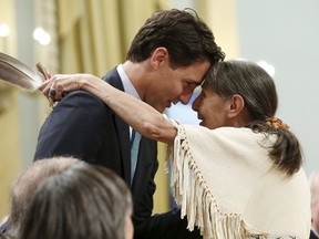 Canada's Liberal Leader Justin Trudeau (L) embraces Elder Evelyn Commanda-Dewache during the Truth and Reconciliation Commission of Canada's closing ceremony at Rideau Hall in Ottawa on June 3, 2015.    REUTERS/Blair Gable