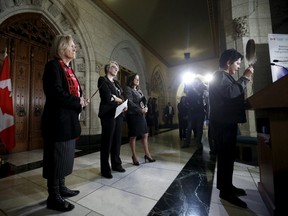 Canada's Indigenous Affairs Minister Carolyn Bennett (L), Status of Women Minister Patricia Hajdu (2nd L) and Justice Minister Jody Wilson-Raybould look on as Algonquin leader Claudette Commanda (R) says a prayer at the start of a news conference detailing an inquiry on missing and murdered indigenous women on Parliament Hill in Ottawa, Canada, December 8, 2015. REUTERS/Chris Wattie