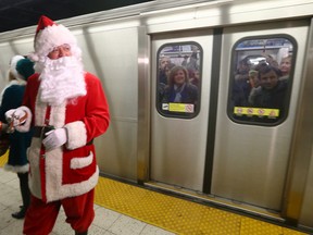 Santa greets TTC riders at Bloor station on Monday, December 14, 2015. (Dave Abel/Toronto Sun/)