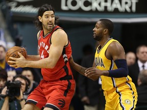 Raptors forward Luis Scola (left) is guarded by Pacers guard C.J. Miles (right) during NBA action in Indianapolis on Monday, Dec. 14, 2015. (Brian Spurlock/USA TODAY Sports)