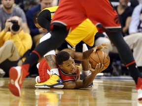 Toronto Raptors guard Kyle Lowry comes up with a loose ball against Indiana Pacers guard Monta Ellis at Bankers Life Fieldhouse in Indianapolis on Dec. 14, 2015. (Brian Spurlock/USA TODAY Sports)