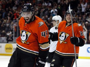 Ducks centre Nate Thompson (left) and centre Mike Santorelli (right) react following a Ducks goal against the Penguins during second period NHL action in Anaheim on Dec. 6, 2015. Thompson was suspended three games for an illegal check to the head of Hurricanes defenceman Justin Faulk last week. (Alex Gallardo/AP Photo)