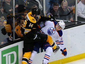 Oilers defenceman Brandon Davidson is upended during the first period of Monday's game against the Bruins in Boston. (USA TODAY SPORTS)