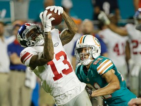 New York Giants wide receiver Odell Beckham makes a catch as Miami Dolphins cornerback Brent Grimes defends during the first half of a game on Dec. 14, 2015. (AP Photo/Wilfredo Lee)