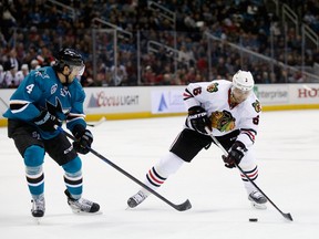 Trevor Daley of the Chicago Blackhawks controls the puck in front of Brenden Dillon of the San Jose Sharks at SAP Center  in San Jose on Nov. 25, 2015. (Ezra Shaw/Getty Images/AFP)