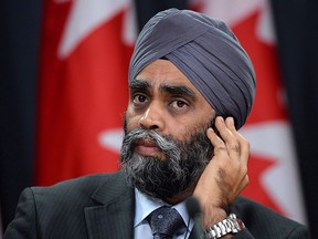 Defence Minister Harjit Sajjan helps announce Canada's plan to resettle 25,000 Syrian refugees during a press conference at the National Press Theatre in Ottawa on Tuesday, Nov. 24, 2015. THE CANADIAN PRESS/Fred Chartrand