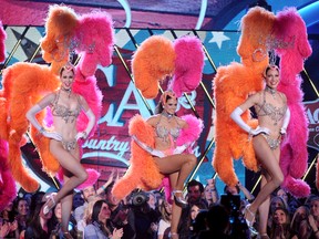 In this Dec. 13, 2013 file photo, Danica Patrick, center, and the Jubilee Showgirls perform onstage at the American Country Awards at the Mandalay Bay Resort & Casino in Las Vegas. (Photo by Frank Micelotta/Invision/AP, File)