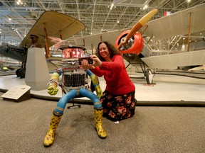 Kim Renolds, Education and Interpretation Officer for the Canada Science and Technology Museum, takes a selfie with Hitchbot the Robot at the Aviation Museum in Ottawa on Tuesday, Dec. 14, 2015. The Canada Science and Technology Museum will be the new home of Hitchbot the robot. Tony Caldwell/Ottawa Sun/Postmedia Network